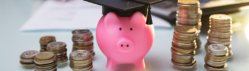 graduation piggy bank ready to make student loan payments