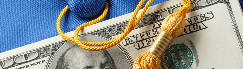 graduation tassel and money set aside for student loan repayment