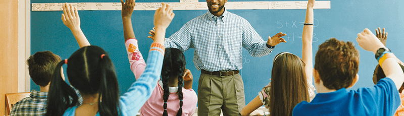 teacher high fiving student after getting student loan forgiveness