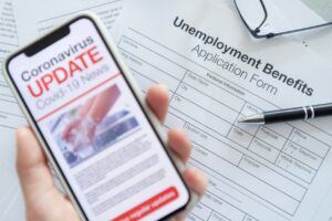 unemployment application - holding phone - coronavirus news
