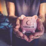 person holding piggy bank - covid-19 savings