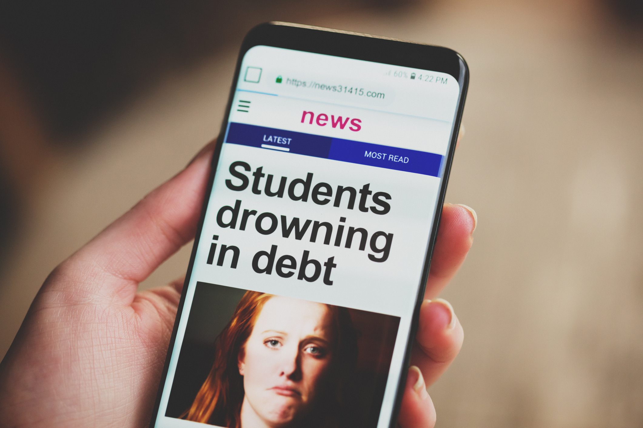 person holding smart phone explore student loan relief options