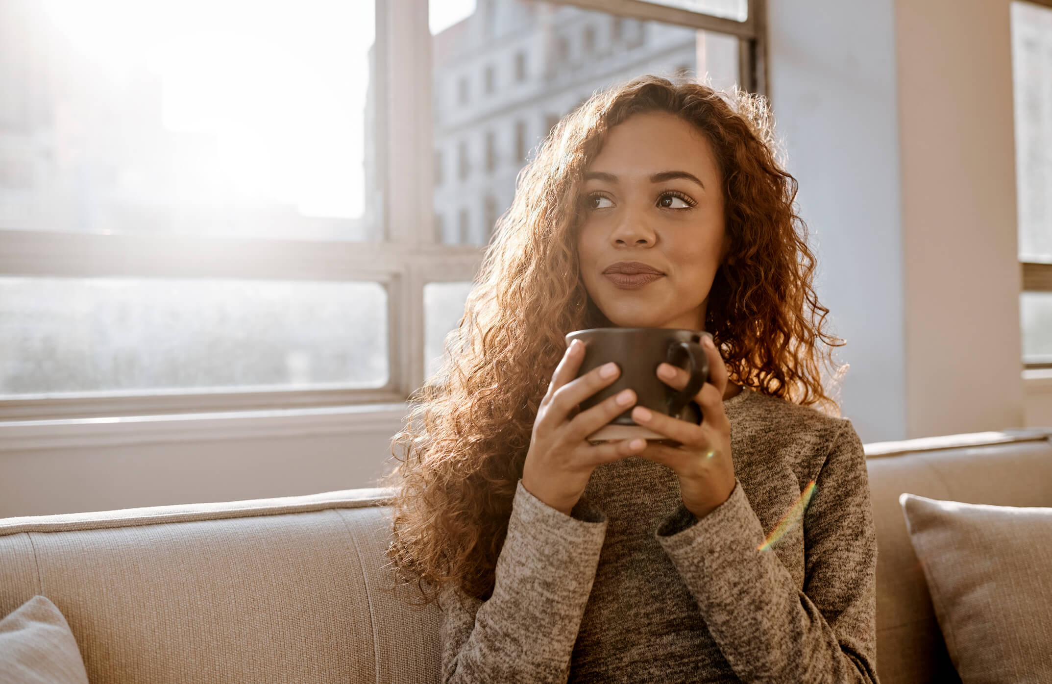 woman drinking coffee and happy about the student loan fresh start initiative