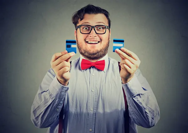man happy to cut credit card in half