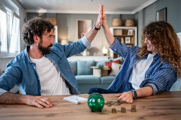 happy couple high five because of debt freedom