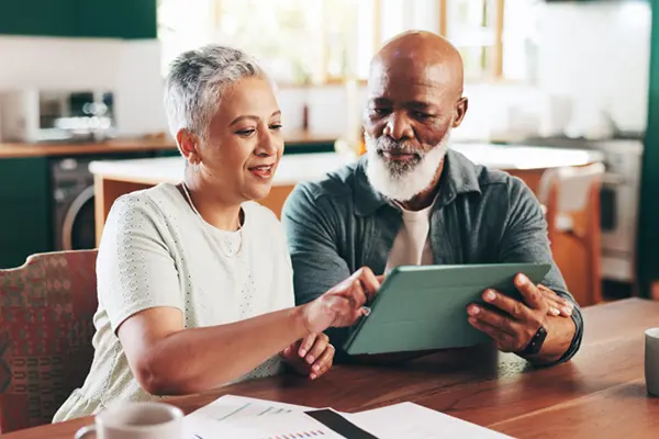senior couple creating an action plan to tackle debt